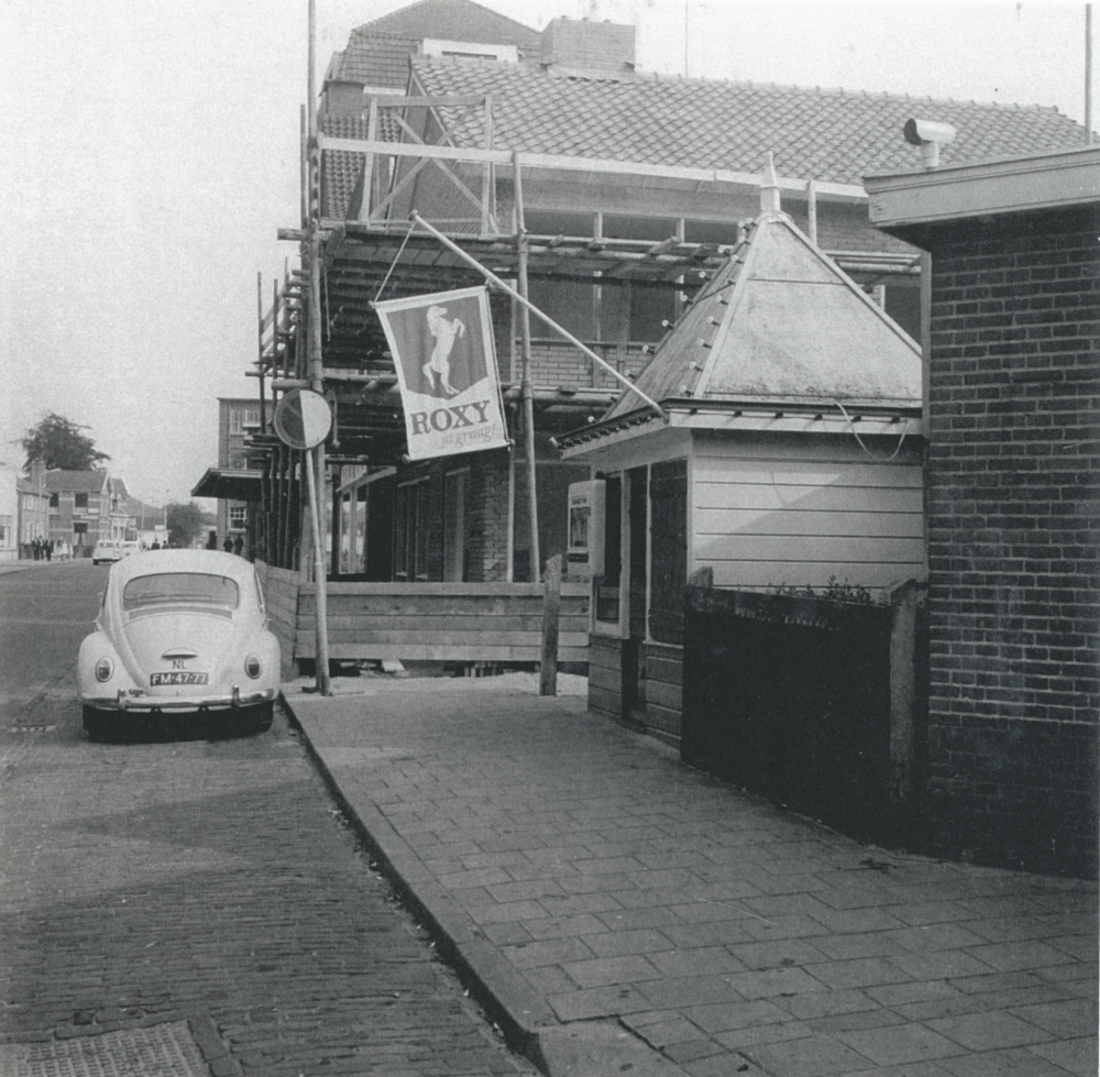 Bekijk detail van "HV10035: De Stationsstraat in Hardenberg, met op de voorgrond de sigarenkiosk 'De Poort' van Harm Gort."