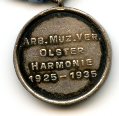 Bekijk detail van "Herinnerings-penning Arbeiders Muziek Vereniging Olster Harmonie, 1925 - 1935"